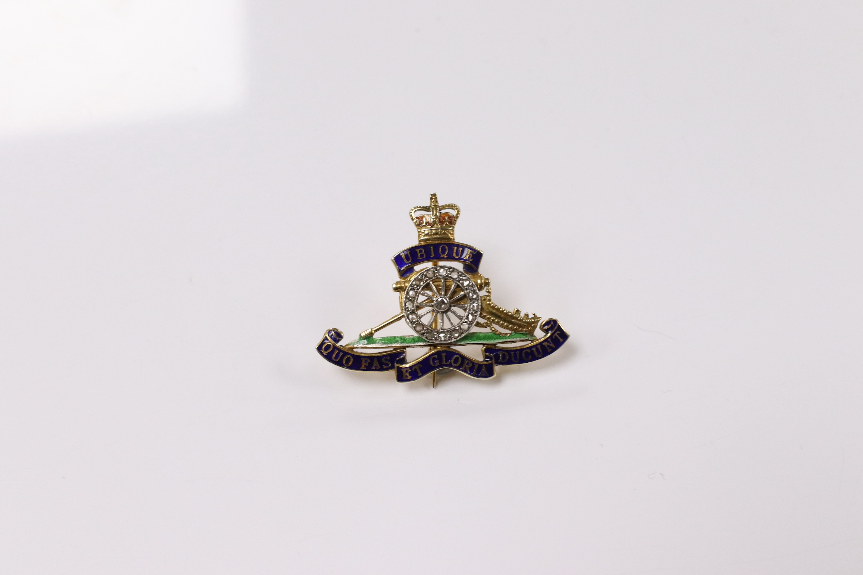 A mid 20th century 9ct gold, diamond and two colour enamel set Royal Artillery sweethearts brooch, 36mm, gross weight 5.7 grams. Condition - poor to fair